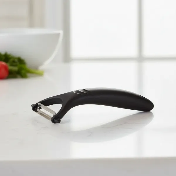 Chef Craft Select Peeler with its black plastic handle and stainless steel swivel blade, designed for ergonomic comfort.